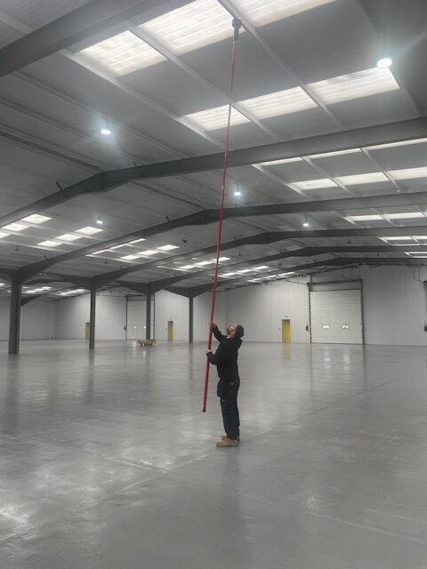 Engineer testing warehouse fire alarm system Foxtail Road Ipswich
