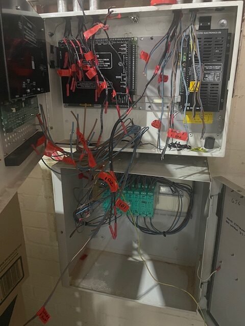 Old commercial fire alarm panel being removed